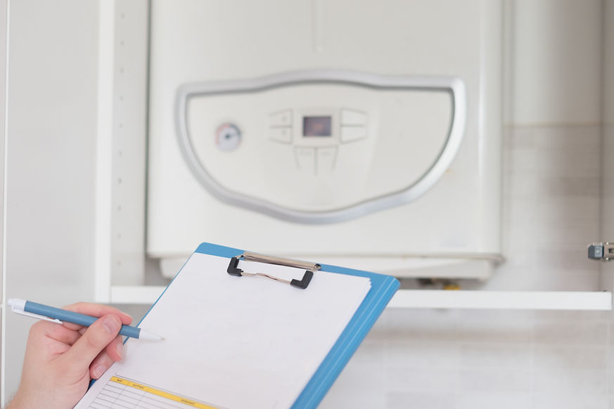 close-up image of a clipboard with a boiler in the background