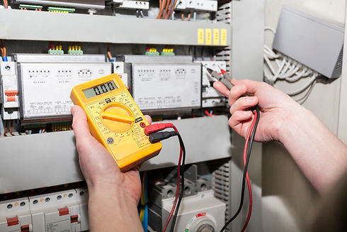 An electrician checking a switchboard
