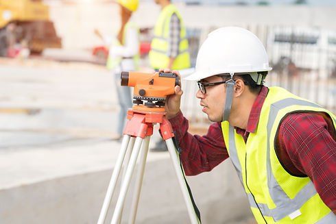 Engineer surveyor working with theodolite at construction site