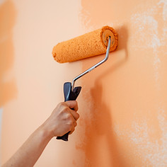 Hand of Woman Painting With Paint Roller on Wall in Apartment