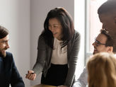 Professional people huddled together in leadership group