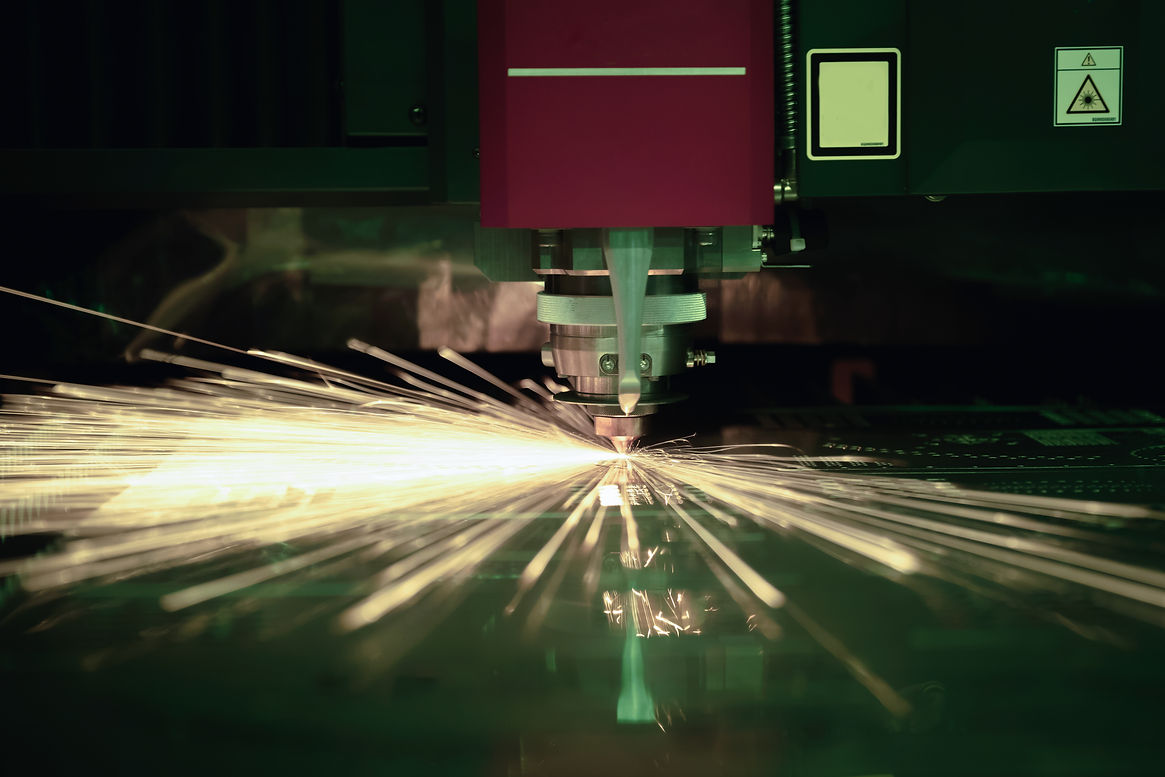 Cutting of sheet metal process with safety glass protection. Sparks fly from laser by auto