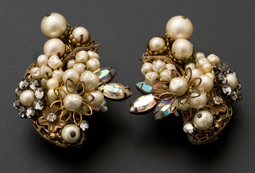 Close-Up Of Earrings Over Grey Background