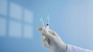 hand holding vaccines