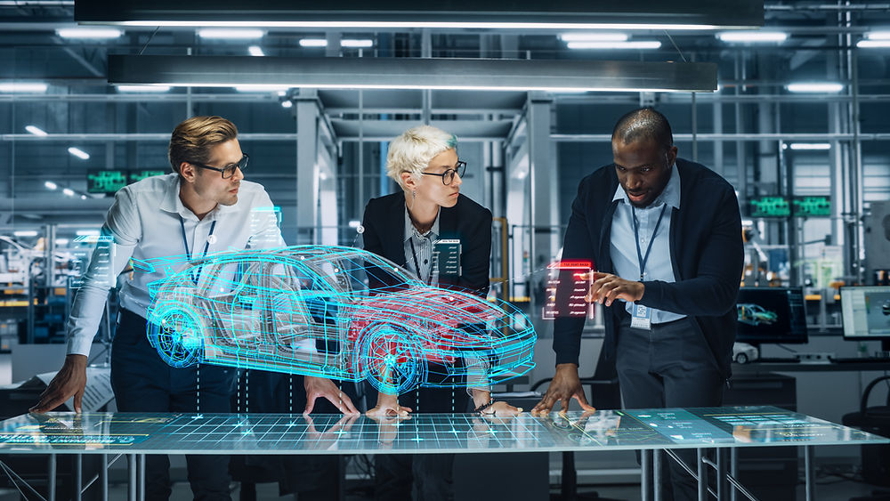 Three engineers examining a 3D holographic car design