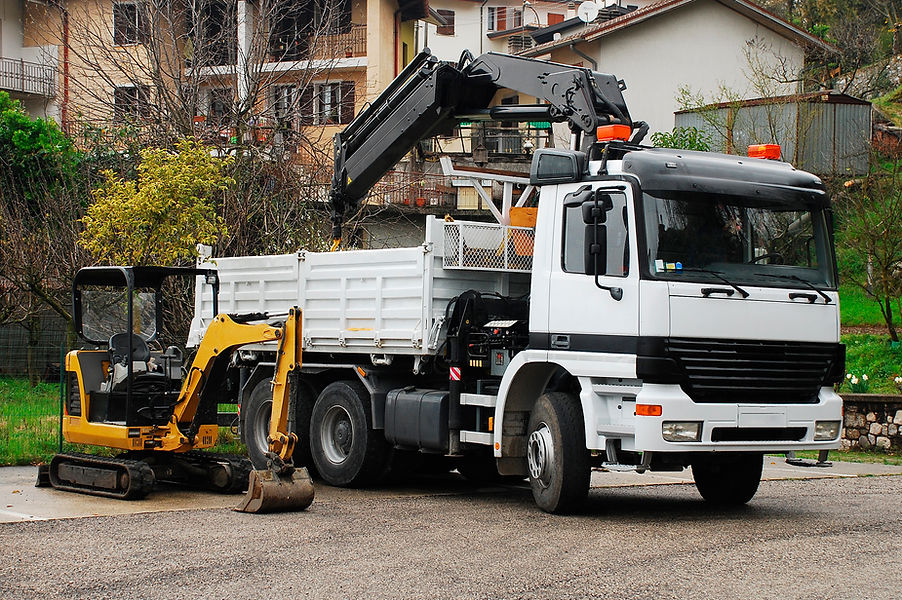 a white truck and an excavator