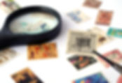 Stamp Collection with Canada stamp being held up to the camera