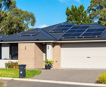 Home with roof-mounted solar panels, illustrating a home energy system