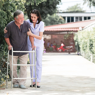 care aid helping a senior with walking