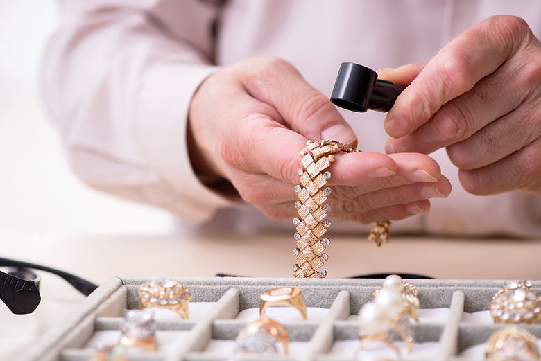 Jeweller looking at a gold chain