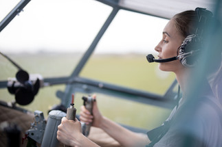 A woman piloting a small plane