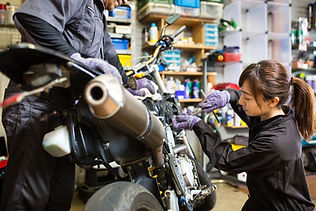 Woman Fixing a Motorcycle