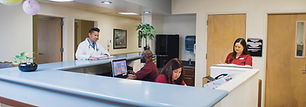 A bustling hospital lobby showcasing healthcare workers at the desk, highlighting the dynamic environment of medical facilities insured by Gaylord Insurance.