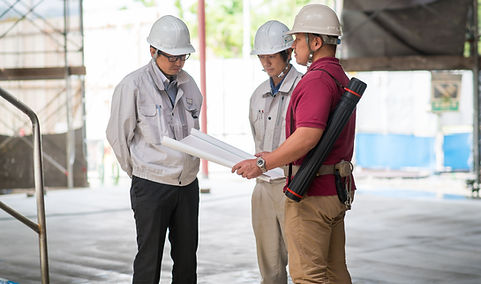 Construction workers looking over plan