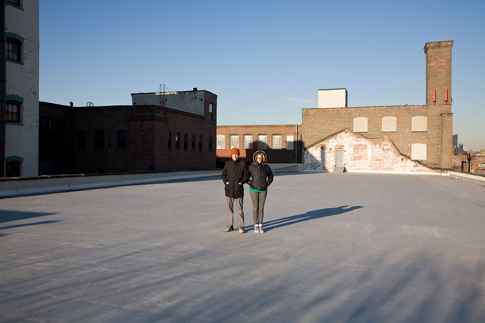Wide commercial flat roof undergoing surface maintenance
