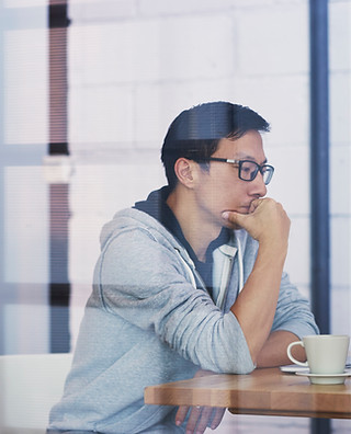 A male Asian developer brainstorming