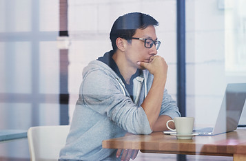 A male Asian developer brainstorming