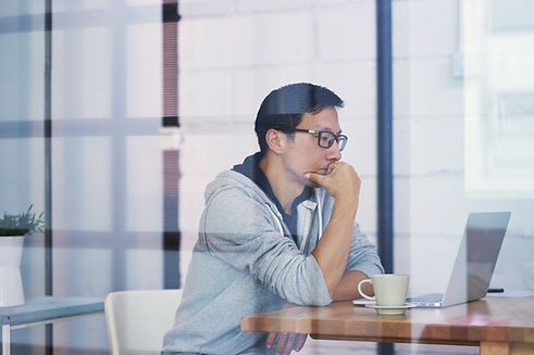 A male Asian developer brainstorming