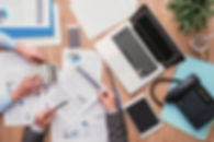 Business team working at office desk and analyzing financial reports