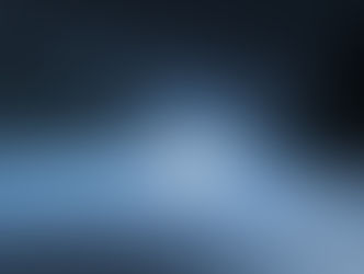 Car drives on a snowy forest road at night, headlights illuminating the icy path. Tall, dark trees line the route, creating a moody scene.