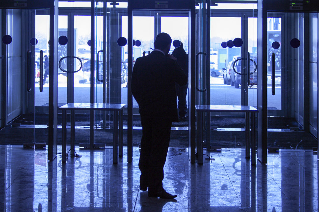 The security guard provides safety on an entrance in large business center