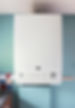 Modern boiler on blue wall in domestic kitchen