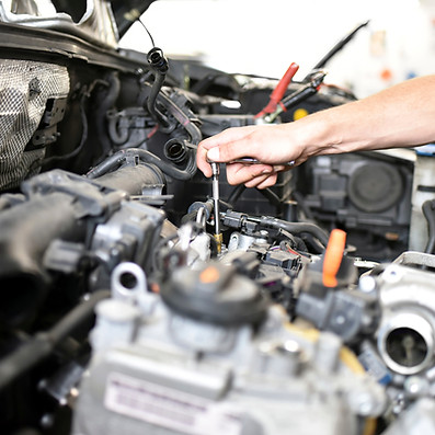 Mechanic repairing car in a garage
