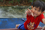 Asian boy reaching for the camera