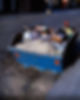 A full-blue dumpster with construction debris