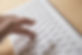 A close-up of a hand resting on a laptop keyboard