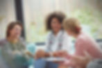 Smiling women talking in a group therapy session