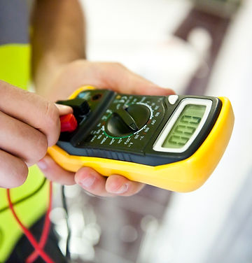 A service technician is using a modern multimeter to test the Voltage