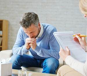 Man in counselling session, in deep thought