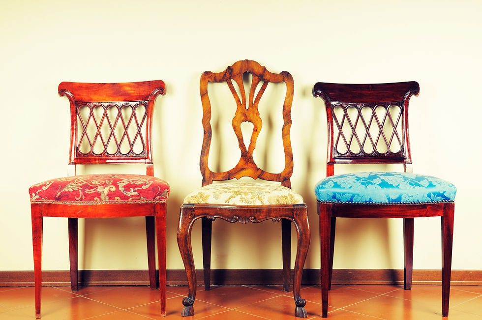 Three vintage wooden chairs reupholstered in decorative fabrics