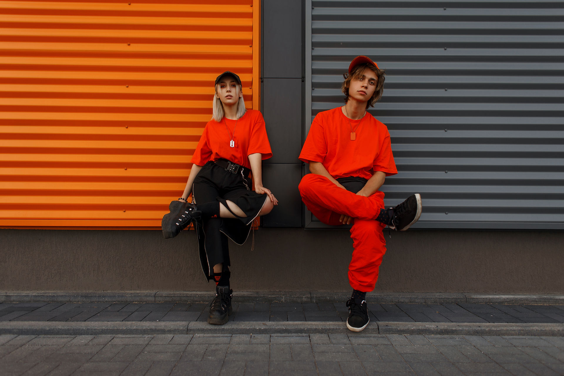 Male and female promotional model wearing red and black uniform during photoshoot