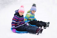 Kids Sledding in Snow