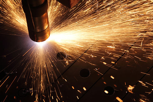Close-up of metal cutting with sparks from machinery