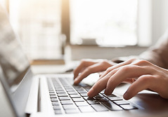 Typing on laptop closeup