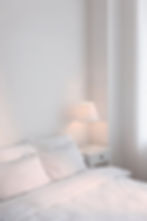 Close-up of a white mattress with a wavy quilted pattern and soft texture, conveying comfort and tranquility. No text visible.