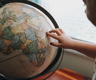 Child Touching Globe