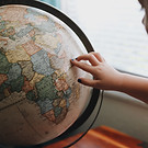 Child Touching Globe
