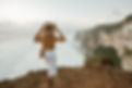 Woman standing on cliff's edge