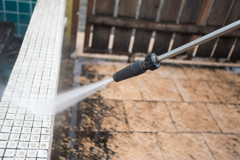 A pressure washer nozzle spraying a powerful jet of water to clean dirt off outdoor tiles