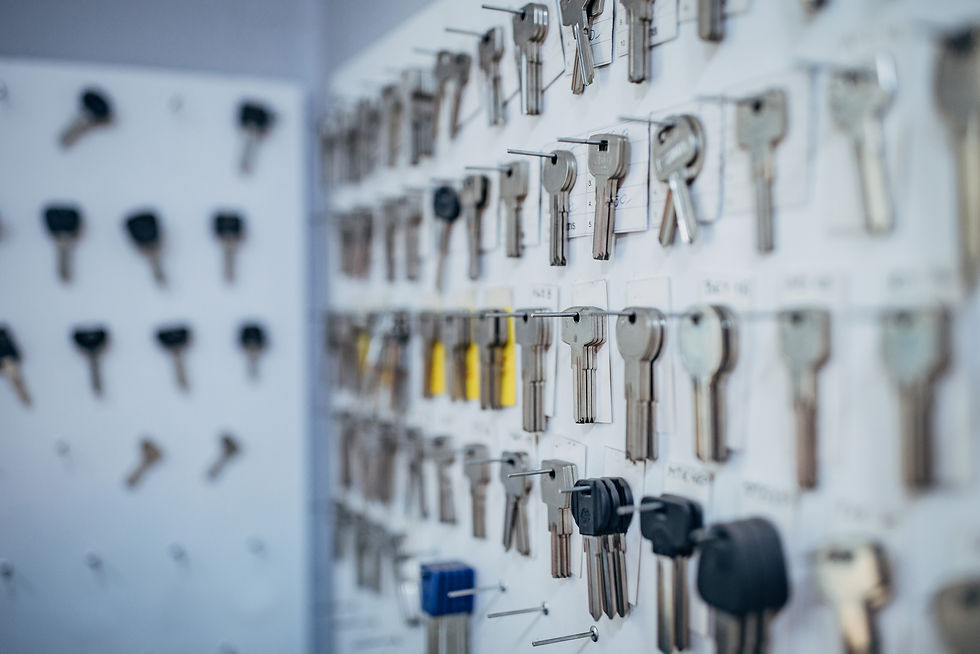 Rows of uncut key blanks hanging on display hooks at a locksmith shop