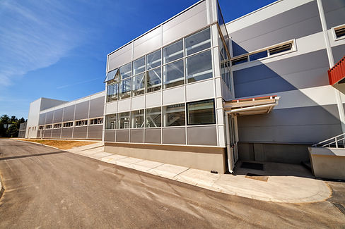 Commercial building exterior featuring professional solar control window film on large glass panels