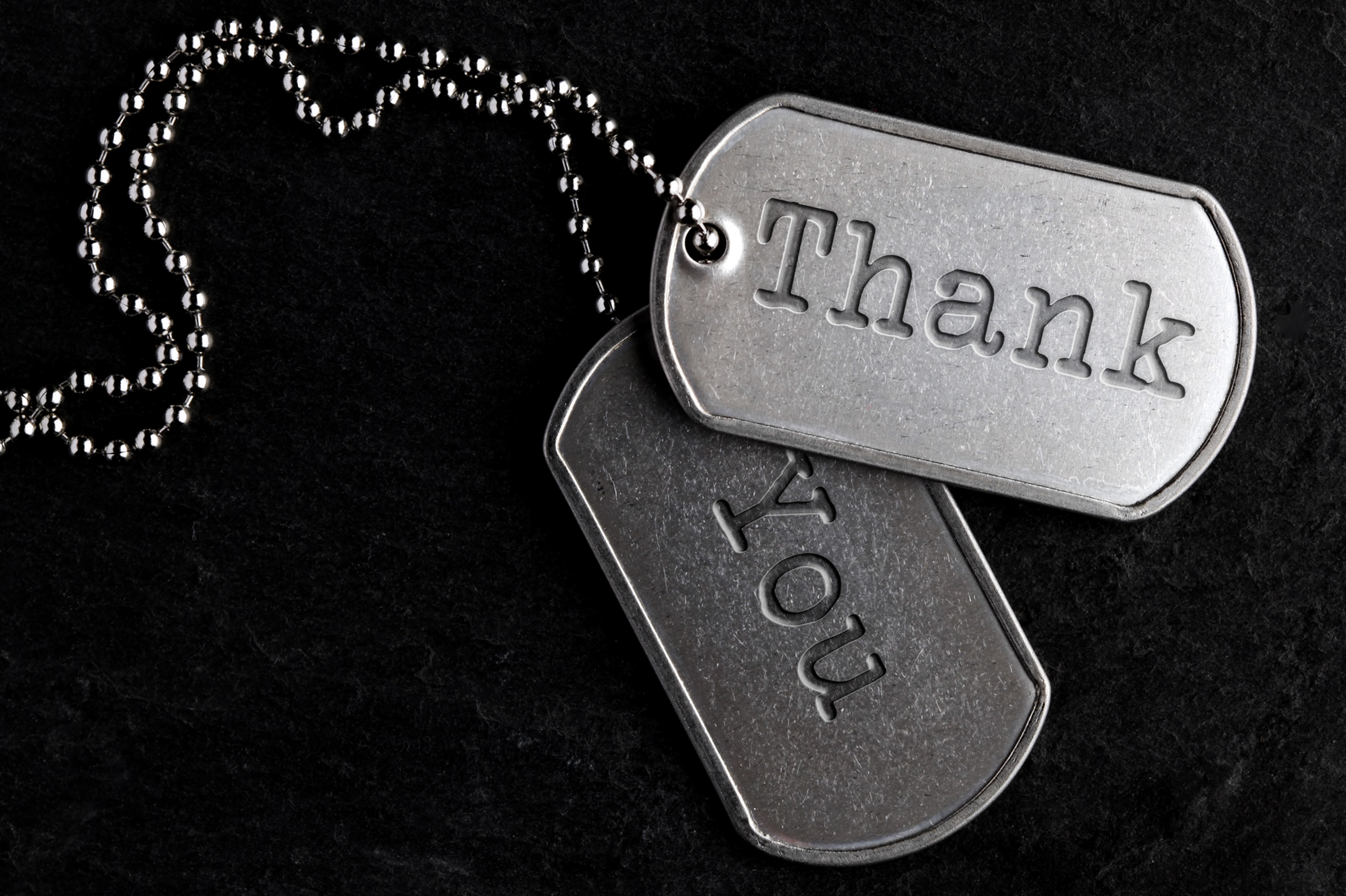 Metal tags with the words Thank You engraved on them.