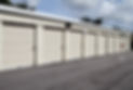 A row of storage units with rolled-up doors
