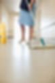 cropped shot of a woman's legs while cleaning floor