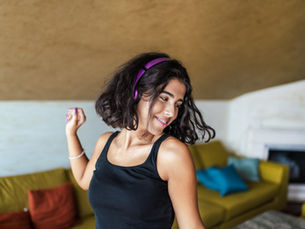 A young woman dancing at home