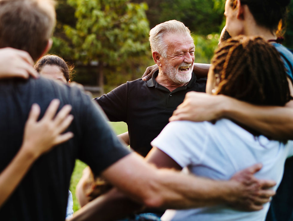 Men doing a group hug symbolizing winning the addiction struggle